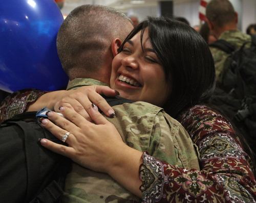 Rick Egan  | The Salt Lake Tribune
Heidi Ward hugs her husband, Christian, at the Salt Lake City International Airport on Friday. Ward was one of 12 airmen from the Utah Air National Guard's 130th Engineering Installation Squadron who returned from a six-month deployment to the Middle East Friday. During their deployment to Qatar and the Persian Gulf region, they installed communications equipment and fiber-optic cable and constructed communications towers.