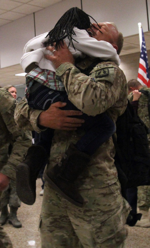 Rick Egan  | The Salt Lake Tribune 

Greg Taylor hugs his daughter Kenley at the Salt Lake City International Airport, Friday, November 16, 2012. Taylor was one of 12 airmen from the Utah Air National Guard's 130th Engineering Installation Squadron who returned from a six-month deployment to the Middle East Friday. During their deployment to Qatar and the Persian Gulf region, they installed communications equipment and fiber-optic cable and constructed communications towers.