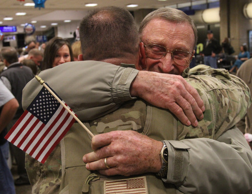 Rick Egan  | The Salt Lake Tribune
Vince Tanner, Pleasant Grove, hugs his dad Charles Tanner, at the Salt Lake City International Airport on Friday. Vince Tanner was one of 12 airmen from the Utah Air National Guard's 130th Engineering Installation Squadron who returned from a six-month deployment to the Middle East Friday. During their deployment to Qatar and the Persian Gulf region, they installed communications equipment and fiber-optic cable and constructed communications towers.