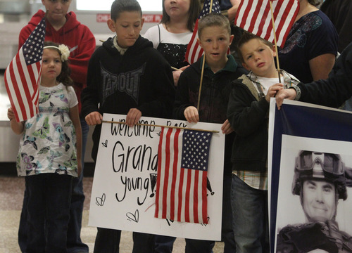 Rick Egan  | The Salt Lake Tribune 

Children wait for their grandfather Randy Young to arrive at the Salt Lake City International Airport, Friday, November 16, 2012. Young was one of 12 airmen from the Utah Air National Guard's 130th Engineering Installation Squadron who returned from a six-month deployment to the Middle East Friday. During their deployment to Qatar and the Persian Gulf region, they installed communications equipment and fiber-optic cable and constructed communications towers.