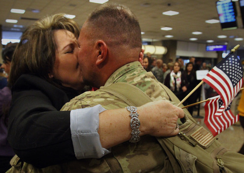 Rick Egan  | The Salt Lake Tribune 

Rochelle Tanner, Pleasant Grove, welcomes her husband, Vince Tanner as he arrives home at the Salt Lake City International Airport, Friday, November 16, 2012. Tanner was one of 12 airmen from the Utah Air National Guard's 130th Engineering Installation Squadron who returned from a six-month deployment to the Middle East Friday. During their deployment to Qatar and the Persian Gulf region, they installed communications equipment and fiber-optic cable and constructed communications towers.
