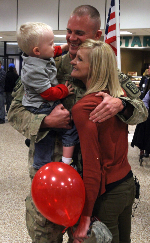 Rick Egan  | The Salt Lake Tribune 

David Hendrickson, Logan, holds his wife Stephanie and 1½-year-old Emmett at the Salt Lake City International Airport, Friday, November 16, 2012. Hendrickson was one of 12 airmen from the Utah Air National Guard's 130th Engineering Installation Squadron who returned from a six-month deployment to the Middle East Friday. During their deployment to Qatar and the Persian Gulf region, they installed communications equipment and fiber-optic cable and constructed communications towers.
