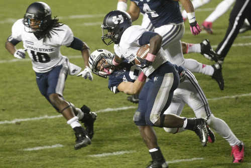 Chris Detrick  |  The Salt Lake Tribune
Utah State Aggies running back Kerwynn Williams (25) runs past Brigham Young Cougars defensive back Daniel Sorensen (9) during the first half of the game at LaVell Edwards Stadium Friday October 5, 2012. BYU is winning the game 6-3.