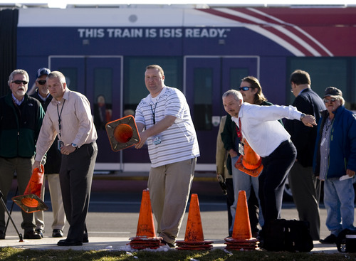 Kim Raff  |  The Salt Lake Tribune
Major construction on the new UTA TRAX line to the Salt Lake City International Airport is now complete. Business owners on North Temple gather to aknowledge the occasion with a "cone toss" near the 1940 West North Temple station in Salt Lake City on Thursday, Nov. 15, 2012.