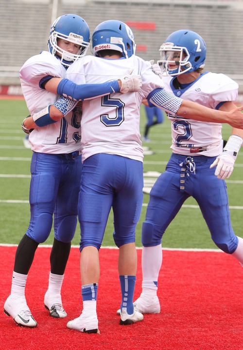 Leah Hogsten  |  The Salt Lake Tribune
Dixie's quarterback Blake Barney is congratulated on his 8yard scoring run.  Dixie High School defeated Spanish Fork High School 49-21 to win the 3A State Championship Football game at Rice Eccles Stadium Friday, November 16, 2012. The win was Dixie's first 3A state football championship since 1998.