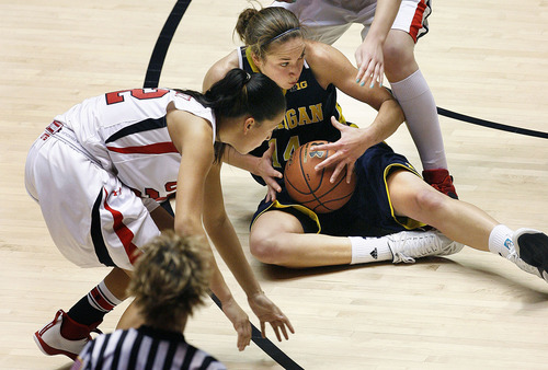 Utah's Chelsea Bridewater, left, surrounds Michigan's Nicole Elmblad during a scramble for a loose ball in the first half of an NCAA college basketball game at the Huntsman Center in Salt Lake City, Utah, Friday, Nov. 16, 2012. (AP Photo/Scott Sommerdorf, The Salt Lake Tribune)