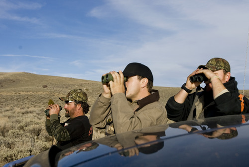 Kim Raff | The Salt Lake Tribune
(from left) David Gurr, Korey Olsen and Ace Redhair look at deer they see nearby during an evening hunt in the Diamond Mountain area outside of Vernal on Oct. 30, 2012. Redhair is a wounded Army veteran who was selected for the first-ever Sgt. Daniel D. Gurr Foundation's deer and elk hunt. David Gurr's son, Daniel, died in Afghanistan in August 2011, and he and his wife, Dana, have created a foundation that takes wounded veterans hunting.