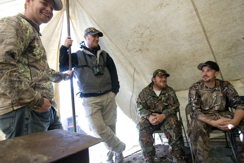 Kim Raff | The Salt Lake Tribune
(middle left) Ace and (middle right) Joey Redhair hang out with friends of David Gurr in a socializing tent at hunting camp in the Diamond Mountain area outside of Vernal on Oct. 30, 2012. The Redhair brothers are wounded Army veterans who were selected for the first-ever Sgt. Daniel D. Gurr Foundation's deer and elk hunt. David Gurr's son, Daniel, died in Afghanistan in August 2011, and he and his wife, Dana, have created a foundation that takes wounded veterans hunting.