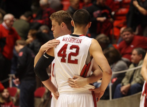 Kim Raff  |  The Salt Lake Tribune
University of Utah players (left) Renan Lenz comforts teammate Jason Washburn after losing in the last seconds to Sacramento State during a men's basketball game at the Huntsman Center in Salt Lake City on November 16, 2012. They went on to lose the game 71-74.