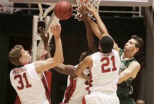 Kim Raff  |  The Salt Lake Tribune
University of Utah players (left) Dallin Bachynski and (middle) Jordan Loveridge battle for a rebound with Sacramento State player (right) Joe Eberhard during a men's basketball game at the Huntsman Center in Salt Lake City on November 16, 2012. They went on to lose the game 71-74.