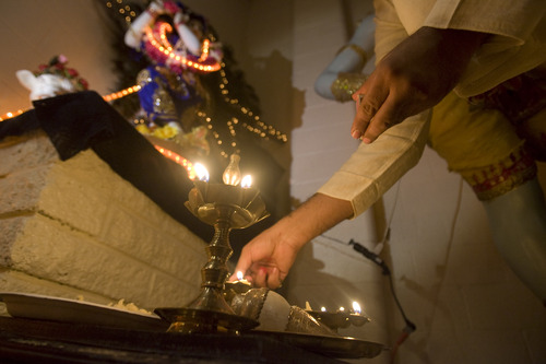 Kim Raff  |  The Salt Lake Tribune
Angada Das lights lamps for people make wishes by placing the lamp down in front of Gods Rama and Sita during the Diwali, the festival of lights, celebration for the Indian New Year at the Krishna Temple in Salt Lake City on November 18, 2012.