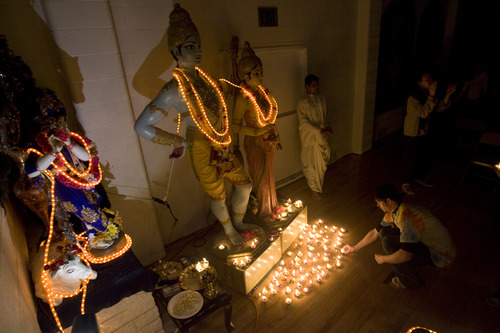Kim Raff  |  The Salt Lake Tribune
People make wishes by placing a lamp down in front of Gods Rama and Sita during the Diwali, the festival of lights, celebration for the Indian New Year at the Krishna Temple in Salt Lake City on November 18, 2012.