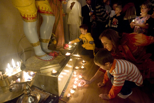 Kim Raff  |  The Salt Lake Tribune
(right) Jennifer and her son Darius Latas place a lamp down in front of Gods Rama and Sita while making a wish during the Diwali, the festival of lights, celebration for the Indian New Year at the Krishna Temple in Salt Lake City on November 18, 2012.