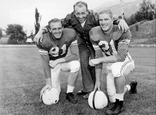 Photo courtesy of BYU

Charles L. (Chick) Atkinson, head football coach at BYU from 1949 to 1955, poses with his 1954 co-captains Marion Probert (left) and Dick Felt. Dick Felt was an all-conference back, graduating in 1958. After service in the U.S. Air Force, he played pro football with the New York Titans (1960-61) and with the Boston Patriots (1962), winning all-pro honors and playing in two all-star games. He joined the BYU coaching staff in 1967 and was the defensive backs coach until 1993.