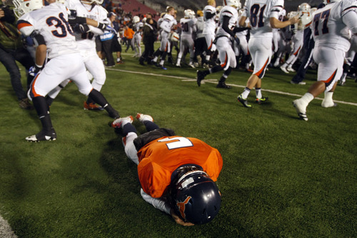 Chris Detrick  |  The Salt Lake Tribune
Mountain Crest's Jamison Webb (5) remains on the field as Timpview celebrates after the 4A championship game at Rice-Eccles Stadium Friday November 16, 2012. Timpview defeated Mountain Crest 38-31