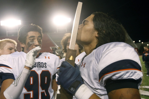 Chris Detrick  |  The Salt Lake Tribune
Timpview's Emmett Tela (58) kisses the trophy after the 4A championship game at Rice-Eccles Stadium Friday November 16, 2012. Timpview defeated Mountain Crest 38-31