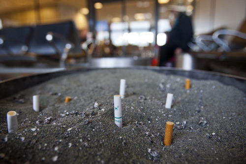 Chris Detrick  |  The Salt Lake Tribune
Cigarette butts in one of the five smoking lounges at the Salt Lake City International Airport on Tuesday. A new Centers for Disease Control study says airports with such designated smoking areas have many times the secondhand smoke pollution as airports that ban indoor smoking.