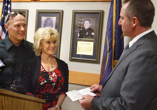 Leah Hogsten  |  The Salt Lake Tribune
Norma Kier and son Steve Kier are thanked by Ogden Police Chief Mike Ashment for their donation. The Kier family donated $10,000 to the department Wednesday to help send family and peers of fallen Ogden police Officer Jared Francom to Washington, D.C. The trip, to be made during National Police Week in May, will include several activities but center on the addition of Francom's name to the National Law Enforcement Officers Memorial Wall.
