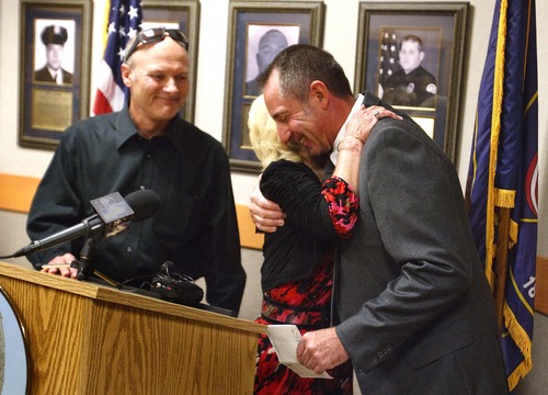 Leah Hogsten  |  The Salt Lake Tribune
Steve Kier, left, smiles as his mother, Norma Kier, hugs Ogden Police Chief Mike Ashment after she donated $10,000 Wednesday November 21, 2012 in Ogden to help send family and peers of fallen Ogden police officer Jared Francom to Washington, D.C. The trip, to be made during National Police Week in May, will include several activities but center on the addition of officer Francom's name to the National Law Enforcement Officers Memorial Wall.