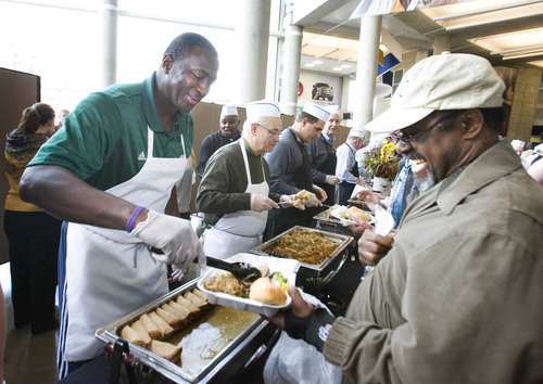 Paul Fraughton  |   The Salt Lake Tribune
Utah Jazz head coach, Tyrone Corbin dishes out the turkey at the Jazz's "We Care-We Share" Thanksgiving dinner celebration for Salt Lake's homeless and low income population. The event was held at Energy Solutions Arena, where food lines and tables filled the concourse areas on Tuesday, Nov. 20, 2012.