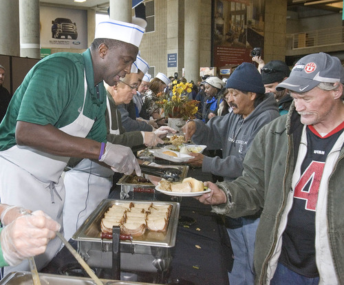 Paul Fraughton  |   Salt Lake Tribune
Utah Jazz head coach, Tyrone Corbin dishes out the turkey at the Jazz's "We Care-We Share" Thanksgiving dinner celebration for Salt Lake's homeless and low income population. The event was held at Energy Solutions Arena, where food lines and tables filled the concourse areas.
 Tuesday, November 20, 2012