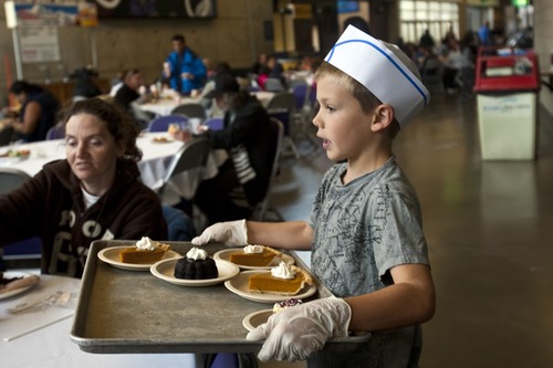 Chris Detrick  |  The Salt Lake Tribune
Brayden Cheney, 8, serves desserts during 'We Care – We Share' Thanksgiving dinner at EnergySolutions Arena Nov. 23. The event was sponsored by the Salt Lake City Mission, EnergySolutions Arena and Utah Food Services. About 3,500 people were served food by 150 Utah Jazz volunteers.
