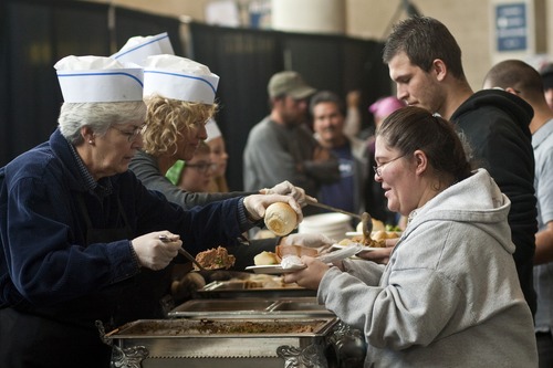 Chris Detrick  |  The Salt Lake Tribune
Gail Miller serves meatloaf to Samantha Castaneda during "We Care – We Share" Thanksgiving dinner at EnergySolutions Arena. The event was sponsored by Salt Lake City Mission, EnergySolutions Arena and Utah Food Services. About 3,500 people were served food by 150 Utah Jazz volunteers.