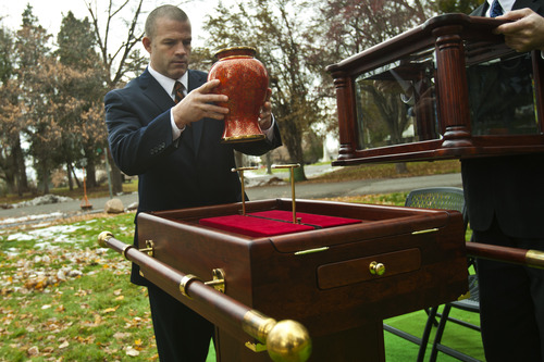 Chris Detrick  |  The Salt Lake Tribune
Spencer Larkin, chief operating officer and vice president of Larkin Mortuary, handles an urn at a funeral at Mount Olivet Cemetery Saturday November 17, 2012.