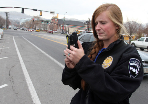 Rick Egan  | The Salt Lake Tribune 

Jen Farrell, parking enforcement officer, takes a photograph of a car that is in violation of the law, before issuing a ticket,  Friday, November 16, 2012.