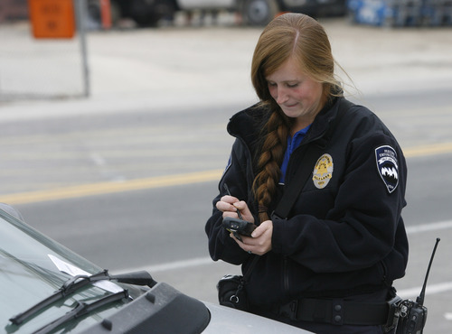 Rick Egan  | The Salt Lake Tribune 

Jen Farrell, parking enforcement officer, puts a ticket on a car, Friday, November 16, 2012.