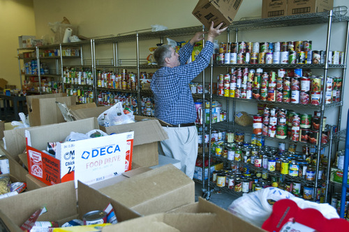 Chris Detrick  |  The Salt Lake Tribune
Keith Barlow helps to organize donated food at the Taylorsville Food Pantry Tuesday November 20, 2012. The last two months of the year are essential for organizations that provide services to Utah's neediest citizens. The Utah Food Bank, for example, collects about 2.5 million pounds of food in drives held from Oct.15 to Jan.15.