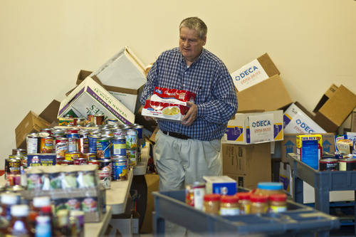 Chris Detrick  |  The Salt Lake Tribune
Keith Barlow helps to organize donated food at the Taylorsville Food Pantry Tuesday November 20, 2012. The last two months of the year are essential for organizations that provide services to Utah's neediest citizens. The Utah Food Bank, for example, collects about 2.5 million pounds of food in drives held from Oct.15 to Jan.15.