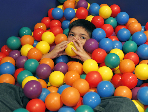 Al Hartmann  |  The Salt Lake Tribune
A student immerses himself in the tactile security of a large bin of rubber balls in the sensory room at Whittier Elementary School. The school has a unique special needs wrap-around service hub that features a sensory room and a physical therapy room to accomodate the needs of Whittier's disabled students.