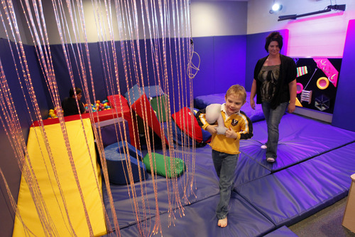 Al Hartmann  |  The Salt Lake Tribune
Instructional assitant supervises a special needs student in the sensory room at Whittier Elementary School.  The dark, quiet, colorful room helps calm special needs students. The school has a unique special needs wrap-around service hub that features the sensory room and a physical therapy room to accomodate the needs of Whittier's disabled students.
