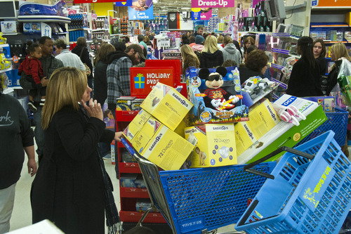 Chris Detrick  |  The Salt Lake Tribune
People shop at Toys"R"Us after they opened at 8:00pm in Murray Thursday November 22, 2012.