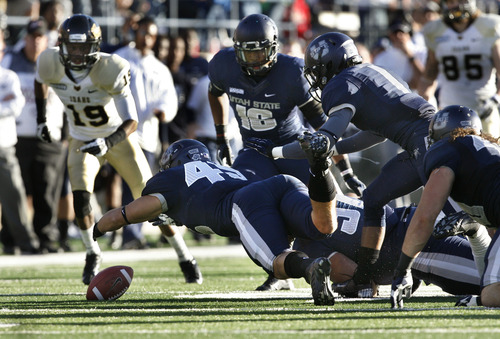 Scott Sommerdorf  |  The Salt Lake Tribune              
Utah State Aggies linebacker Forrest Dabb (49) recovers a fumble by Idaho Vandals quarterback Taylor Davis (12) during second half play. Utah State defeated Idaho 45-9 in Logan, Saturday, November 24, 2012 to become champions of the WAC.