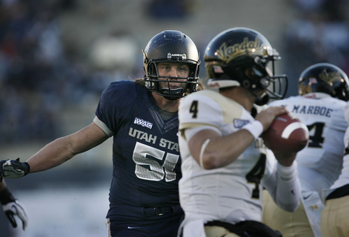 Scott Sommerdorf  |  The Salt Lake Tribune              
Utah State Aggies linebacker Jake Doughty (51) rushes in untouched on Idaho Vandals quarterback Logan Bushnell (4) during second half play. Utah State defeated Idaho 45-9 in Logan, Saturday, November 24, 2012 to become champions of the WAC.