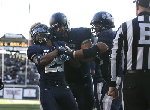 Scott Sommerdorf  |  The Salt Lake Tribune              
Utah State players celebrate with Utah State Aggies running back Kerwynn Williams (25) after he scored on a 14 yard run to give USU a 38-9 lead. Utah State defeated Idaho 45-9 in Logan, Saturday, November 24, 2012 to become champions of the WAC.