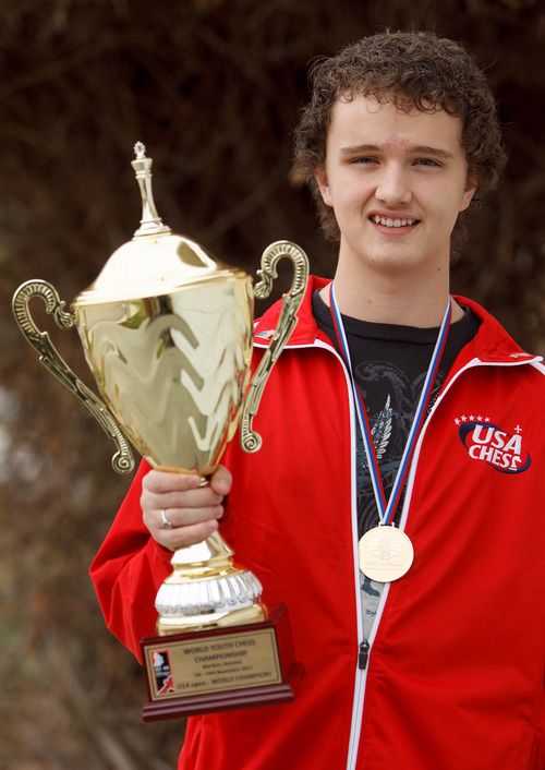 Trent Nelson  |  The Salt Lake Tribune
Chess champ Kayden Troff displays his trophy and gold medal Wednesday in West Jordan. He took first place in the world among 13- to 14-year-olds in the World Youth Chess Tournament in Slovenia.