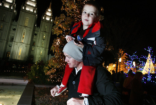 Scott Sommerdorf  |  The Salt Lake Tribune              
Colton Omer holds his son, Taylor Omer as they walk through Temple Square looking at the lighting of holiday display at Temple Square, Friday, November 23, 2012.