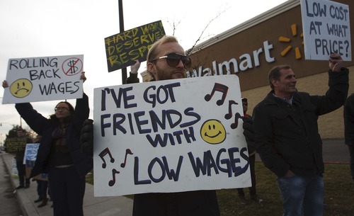 Leah Hogsten  |  The Salt Lake Tribune
Stewart Thorpe (center) protests Walmart's low wages on behalf of his two friends who work at other locations in the Salt Lake Valley.    
 Friends and family of Walmart employees protested working conditions during a Walmart Workers Walkout Solidarity Rally on Black Friday at the Walmart located at 300 West and 1300 South, Salt Lake City Friday November 23, 2012 in Salt Lake City.