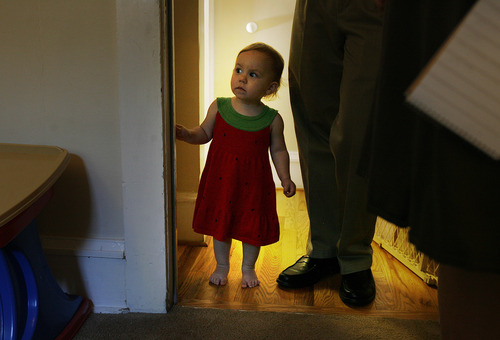 Scott Sommerdorf  |  The Salt Lake Tribune             
Bertrand Might's younger sister, Victoria, peeks around a corner to see what is going on as her brother gets physical therapy at home, Thursday, August 2, 2012.