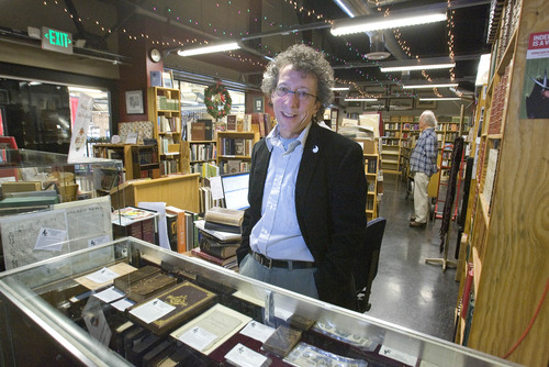 Paul Fraughton | The Salt Lake Tribune
Tony Weller of Weller Book Works in Trolley Square stands behind  a display case holding rare LDS books. Tony and his wife Catherine spoke at the monthly Zions Bank press conference on on the Wasatch Front Consumer Price Index.
 Tuesday, November 27, 2012