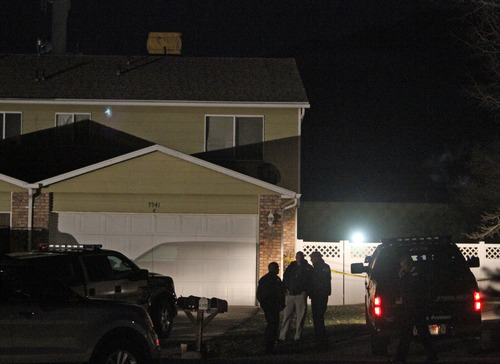 Rick Egan  | The Salt Lake Tribune 
Police wait outside a house on Chadbourne Drive in Cottonwood Heights, where a woman was killed Monday, Nov. 26, 2012. Police say, and officers have taken two people into custody.