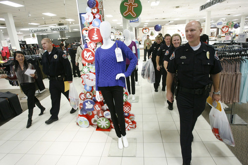 Francisco Kjolseth  |  The Salt Lake Tribune
West Valley City Police officers kick off the West Valley City Giving Tree at Valley Fair Mall on Tuesday, Nov. 27, 2012, benefiting 176 youth from 58 families. Those interested in supporting the program can choose and check out a name from the trees located near the Valley Fair Mall Customer Service Center; service representatives will provide a list of the child's needs and holiday wishes. Shoppers are then asked to return the unwrapped gifts to the desk before Dec. 15. The West Valley City Police Department's Community Services Section started the tradition several years ago when a family they were working with experienced multiple tragedies and were left with no resources for the holidays. The department now coordinates with a local organization that works with low-income families in the city to choose names for the tree.