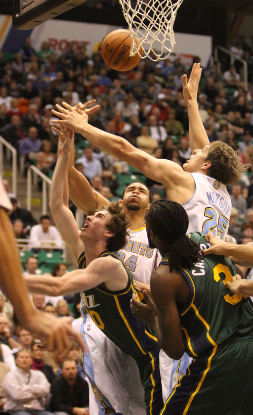 Rick Egan  | The Salt Lake Tribune 

Utah Jazz shooting guard Gordon Hayward (20)is double teamed by Denver Nuggets point guard Andre Miller, and  Timofey Mozgov (25)as he goes up for a shot,  in NBA action, Utah vs. the Denver Nuggets, in Salt Lake City, Monday, November 26, 2012.
