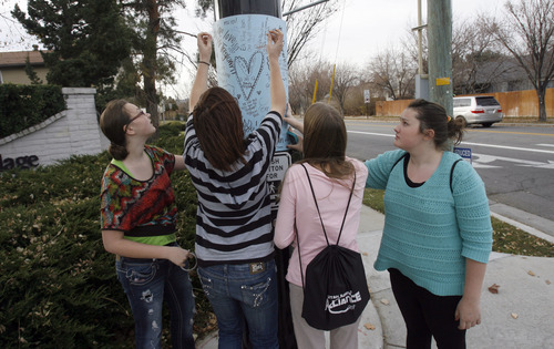 Francisco Kjolseth  |  The Salt Lake Tribune
Elk Ridge Middle School students Tiffany Osborne, 14, Cassidy Blackham, 15, Paige Adams, 13, and Allison Beal, 14, from left, put up a poster board in honor of P.E. teacher Randy Treglown, 51, at the intersection where he was struck and killed by a car at the corner of 4000 West and 9800 South in South Jordan as he jogged to work early Wednesday, November 28, 2012. "He was tough but he wanted kids to learn a healthy lifestyle," exclaimed Beal who had him as a gym teacher this year.
