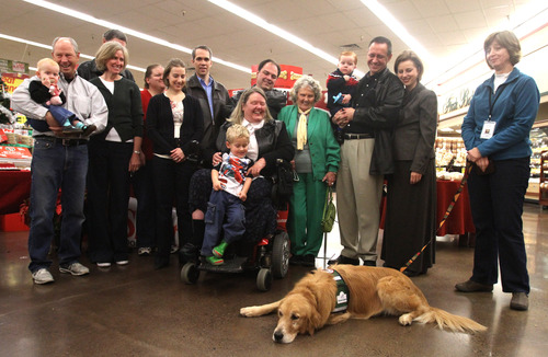 Rick Egan  |  The Salt Lake Tribune 
Wanda Woodrum, of Pleasant Grove, gathers with her family and friends to meet Barnsley, the ambassador dog for Canine Assistants, at Smith's in Provo on Thursday. Woodrum will receive her dog in January 2013 when she travels to Alpharetta, Ga., for a two-week training camp.