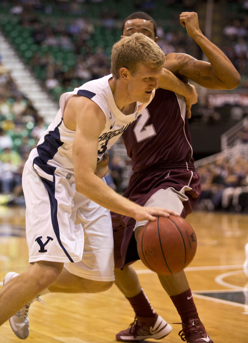 Lennie Mahler  |  The Salt Lake Tribune
BYU's Tyler Haws drives around Montana's Kevin Henderson in the Cougars' 85-60 win over the Grizzlies at EnergySolutions Arena, Wednesday, Nov. 28, 2012.