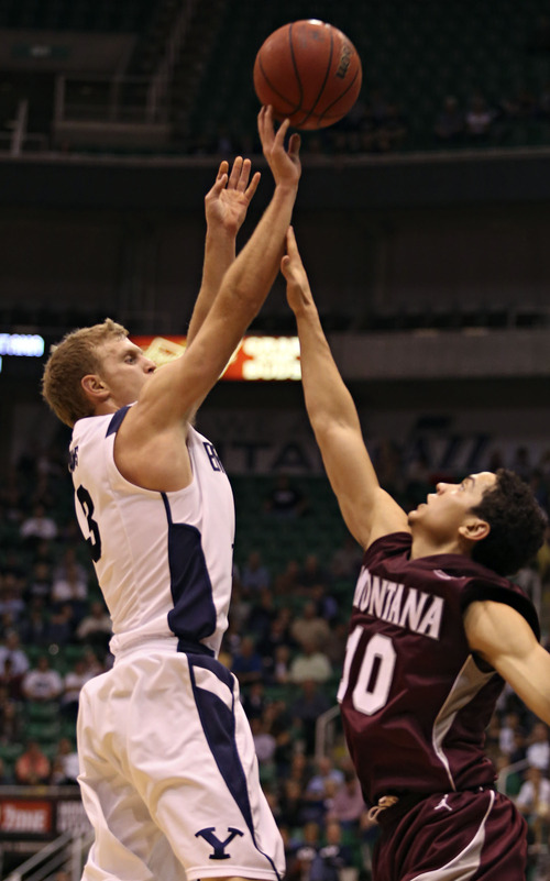 Lennie Mahler  |  The Salt Lake Tribune
BYU's Tyler Haws draws a foul and makes the basket over Montana's Jordan Gregory in the Cougars' 85-60 win over the Grizzlies at EnergySolutions Arena, Wednesday, Nov. 28, 2012.